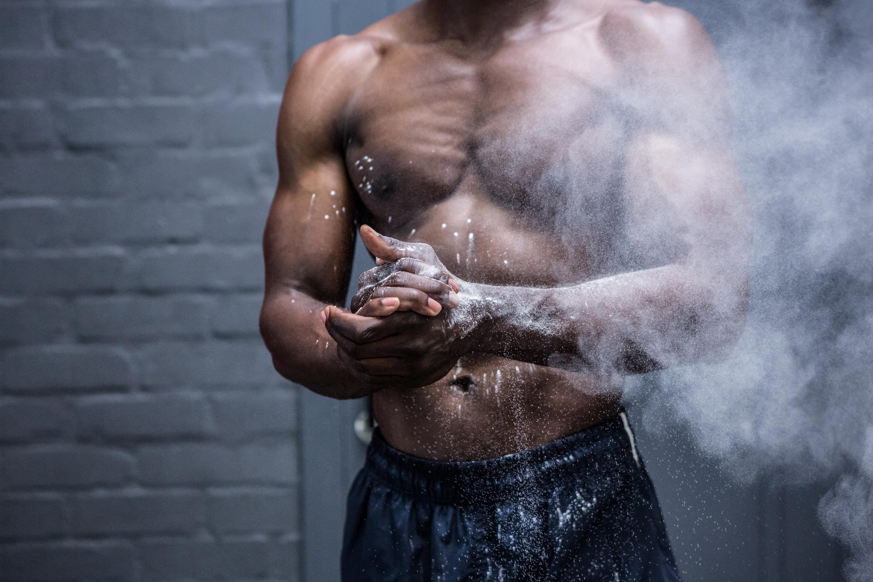 athlete clapping hands with chalk